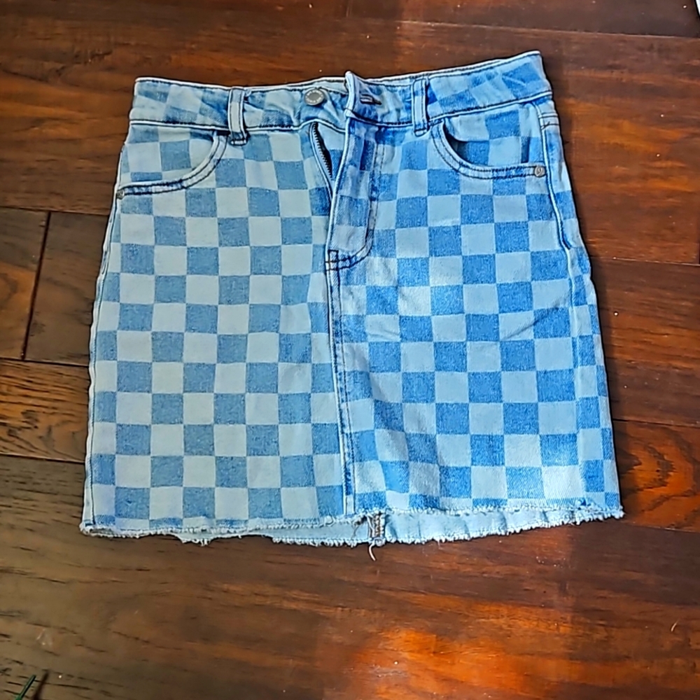 I am selling a checkered skirt that is blue and acid washed.